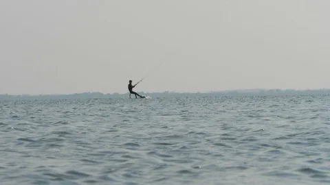 Skillful kiteboarder rides fast on open sea slow motion Stock Footage 118993280