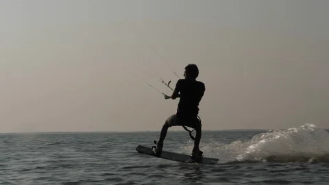 Skillful kitesurfer does back roll in jump slow motion Stock Footage