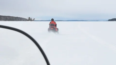 Skillful man in warm red jacket drives fast snowmobile 스톡 동영상 109203655