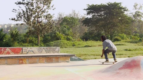 Skillful skateboarder jumping on the grind box in the skatepark  Stock Footage 112986156