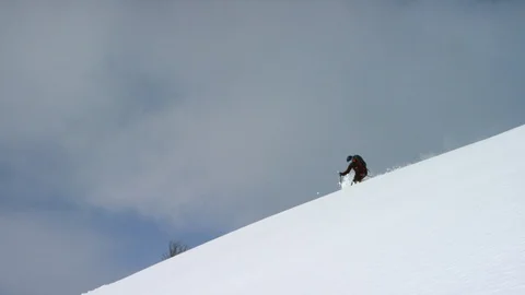 Skillful skiers skiing down the slope of snow capped Stock Footage 116786857