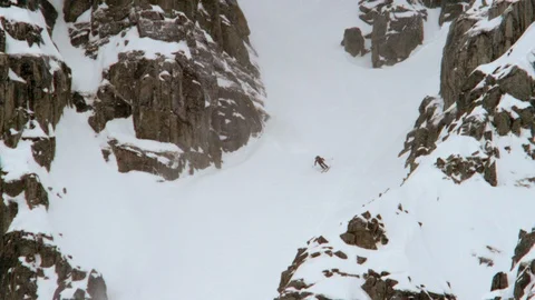 Skillful skiers skiing down the slope of snow capped Stock Footage 116786897