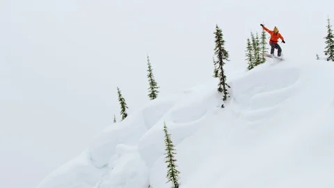 Skillful snowboarder jumping and performing stunts on the snow covered mountain Stock Footage 116788454