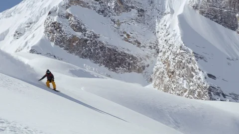 Skillful snowboarder shredding down snowy mountain slope Stock Footage 116788512