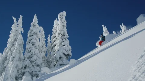 Skillful snowboarder sliding in deep powder snow on a steep slope Stock Footage 116783387