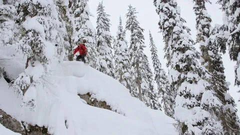 Skillful snowboarder umping on the snow covered mountain Stock Footage 116783090