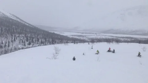 Skillful snowmobile driver jumps fast on big white snowdrift Stock Footage 112533483