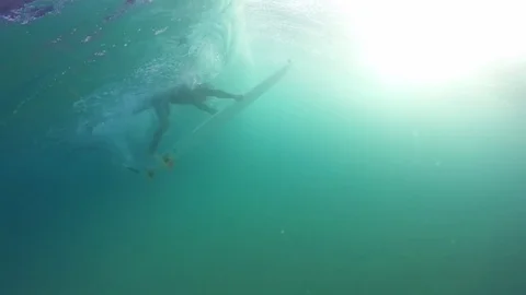 Skillful surfer diving under the turquoise sea Stock Footage 71542454