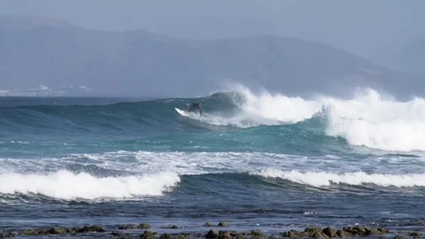 Skillful surfer riding a big wave Stock Footage 71537805