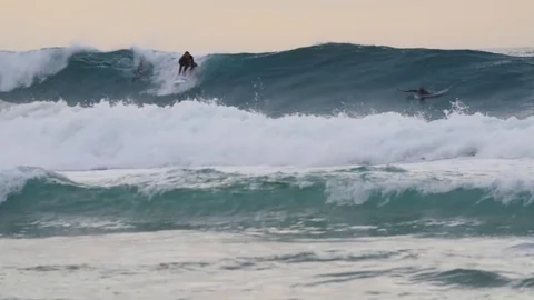 Skillful surfer surfing a big wave during sunset Stock Footage 71540912