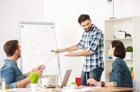 Skillful three workers have discussion in office Foto stock
