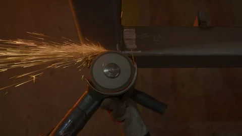 Skillful worker slices metal with angle grinder in hand Stock Footage 303110320