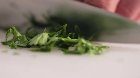 Skillfully chef chopping fresh green herbs on cutting board Stock Footage 274242482