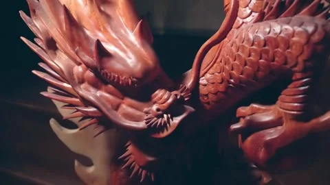 Skillfully crafted and intricately carved from red wood statue of a dragon Видео 333315004