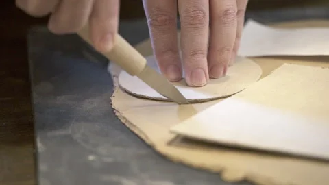 Skillfully Crafting Leather Patterns Utilizing Precision Tools for Exceptional Stock Footage 284927634
