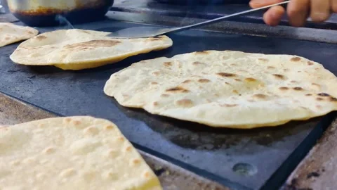  skillfully preparing fresh chapatis  Stock Footage 245324472
