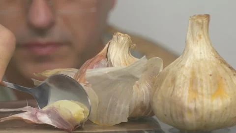 Skillfully preparing fresh garlic enhances a variety of culinary dishes and Video stock 283459042