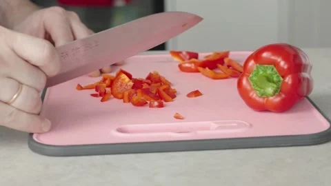 Skillfully slicing juicy red bell peppers on camera Stock Footage 269119953