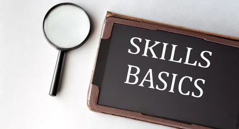 SKILLS BASICS - words in electronic notebook on white background with magni.. Stock Photos