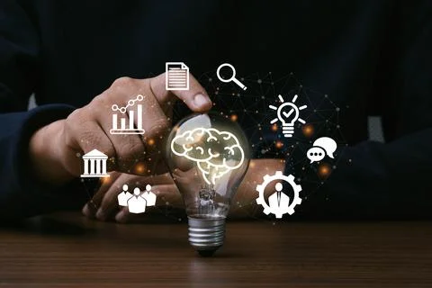 Skills,Knowledge and Ability.Man hand touching light bulb with icon of skil.. Stock Photos