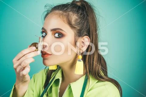 Skin care. Massage with snail. Skincare repairing. Healing mucus. Having fun Stock Photos