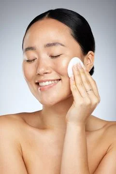 Skincare, asian and woman cleaning face with soft cotton pad for healthy and Stock Photos