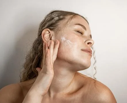 Skincare Routine Effectively Applying Moisturizer on Beautiful, Glowing Skin for Stock Photos