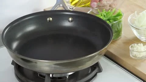 Skinned salsiccia being placed in a hot pan and fried Stock Footage 24672594
