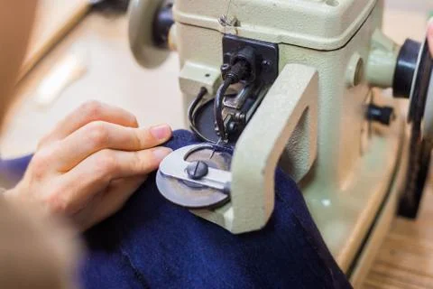 Skinner using sewing machine for stitching fur skin at atelier Stock Photos