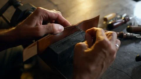 Skinner working with leather. Stock Photos