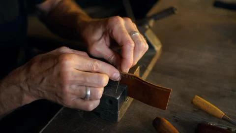 Skinner working with leather. Stock Photos