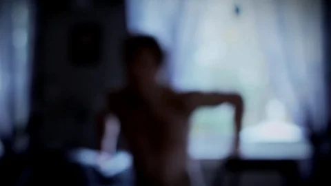 Skinny man doing dips by a window Stock Footage 84790684