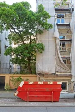 Skip Construction Site Big Red Skip Container at Construction Site in City... Stock Photos