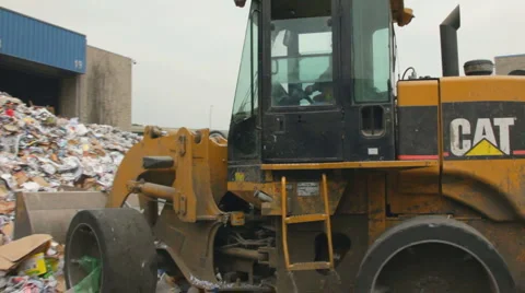 SKIP-LOADER MOVES RECYCLABLABLES Stock Footage 6526215