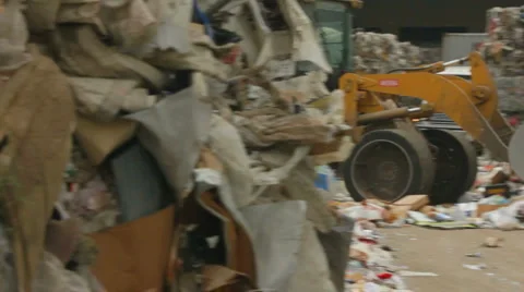 SKIP-LOADER PUSHES RECYCLABLES Stock Footage 6530266