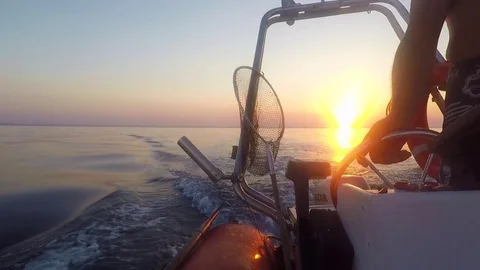 Skipper navigating at sunset Video stock 77732444