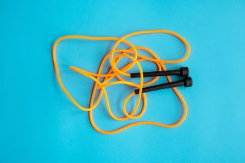 Skipping rope on blue background. Skip rope. Stock Photos