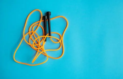 Skipping rope on blue background. Skip rope. Stock Photos