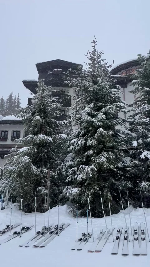 Skis on the slopes in front luxurious Les Airelles Courchevel hotel Stock Footage 336966842