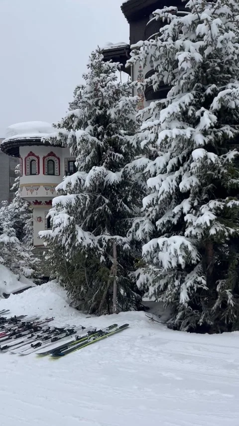 Skis on the slopes in front luxurious Les Airelles Courchevel hotel Stock Footage 337095861