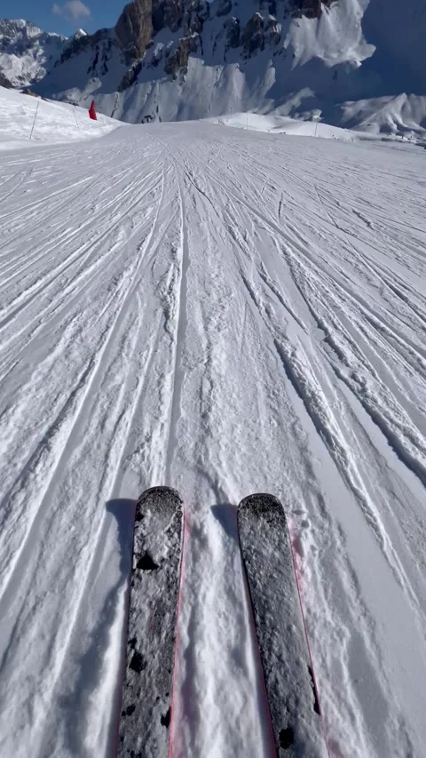 Skis on the slopes at high speed with snowcapped Mountain View Stock Footage 334410434