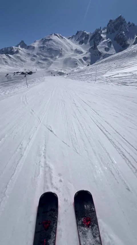 Skis on the slopes at high speed with snowcapped Mountain View Stock Footage 334441504