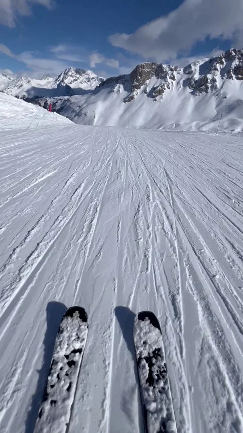 Skis on the slopes at high speed with snowcapped Mountain View Stock Footage 336928679
