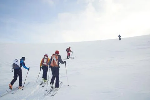 Skitouring group with mountain views in winter Stock Photos