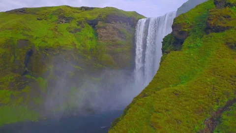 Skogafoss waterfall flowing down a mossy cliff in Iceland Stock Footage 330269647
