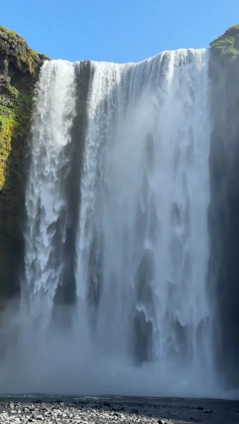 Skogafoss waterfall in full flow under a bright sunny sky, South Iceland Stock Footage 331560597