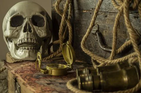 Skull and adventure objects for exploration. Stock Photos