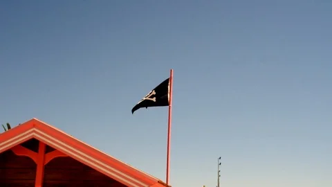 A Skull and Bones pirate flag, with black background Stock Footage 100883765