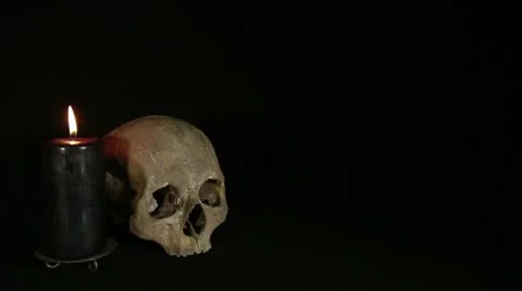Skull and candle on the black background Stock Footage 14902174