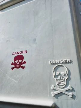 Skull and crossbones danger warning on metal Stock Photos